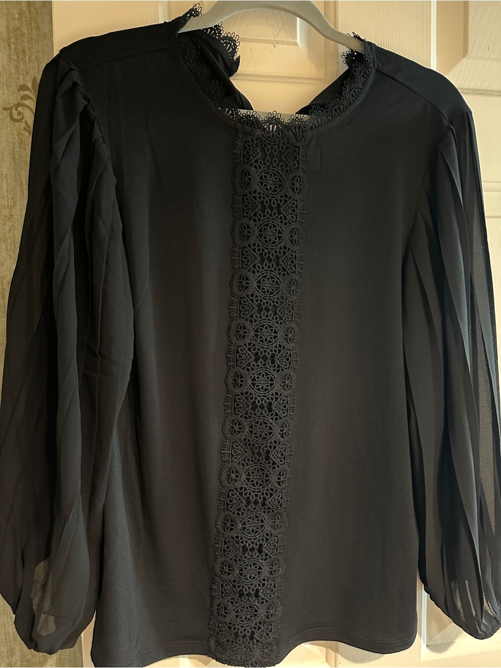 Never worn, black top with embellished front and sheer blouson sleeves